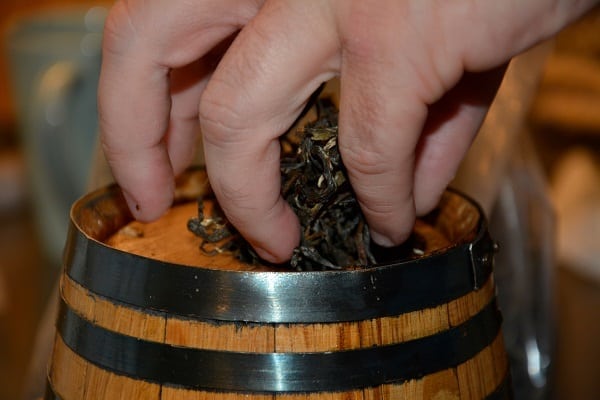 putting the leaves in the barrel